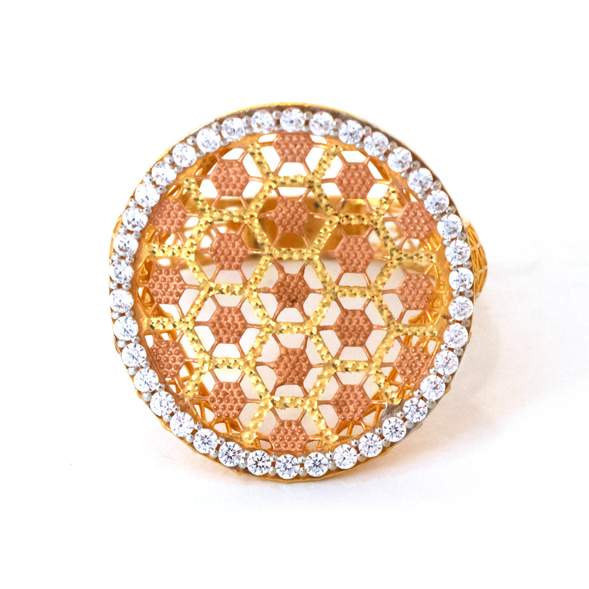 Gold and rose gold ring with diamond-studded band on a white background