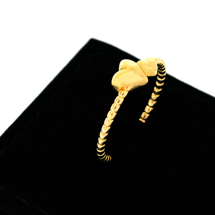 Gold bracelet with a unique design on a black background