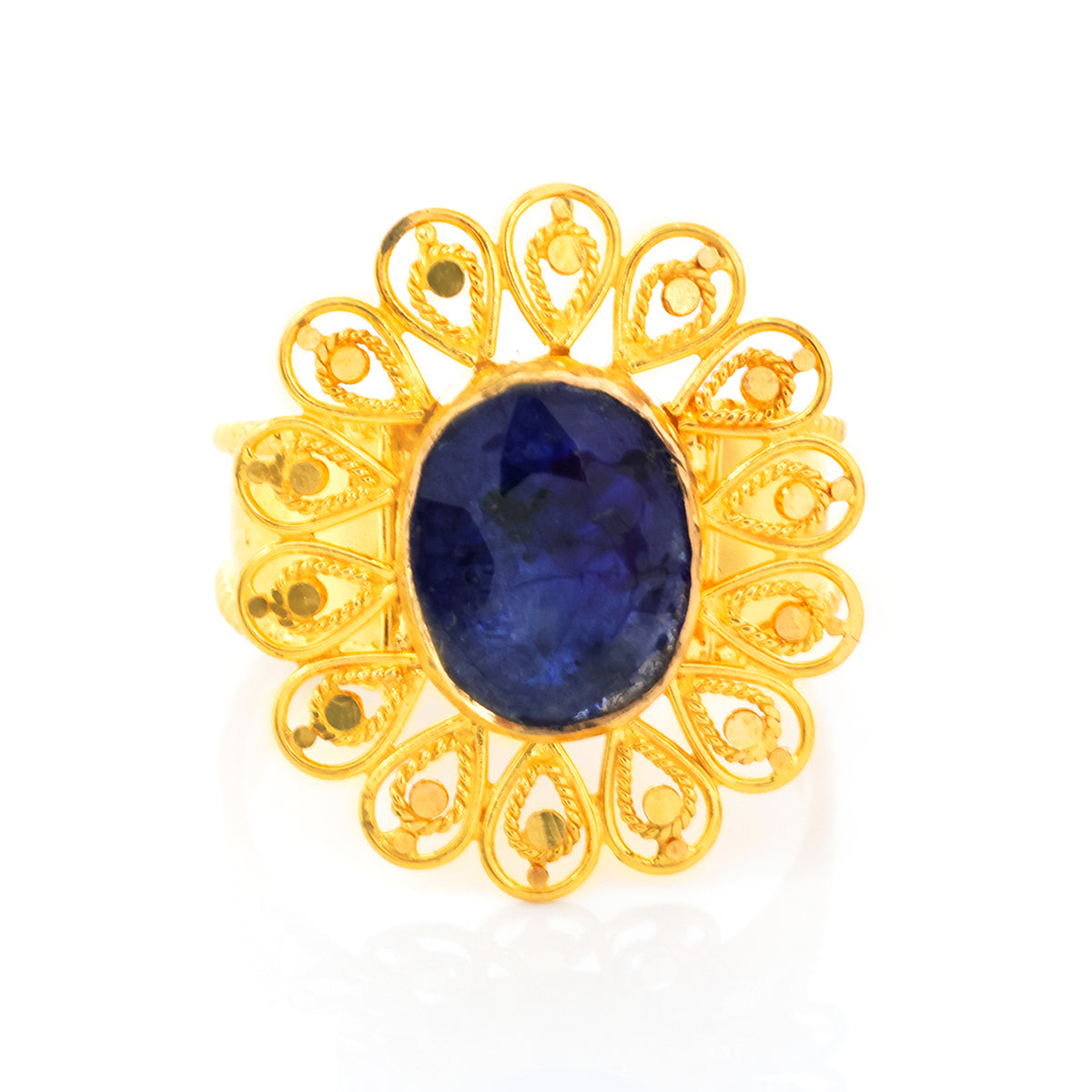 Gold ring with a blue gemstone on a white background