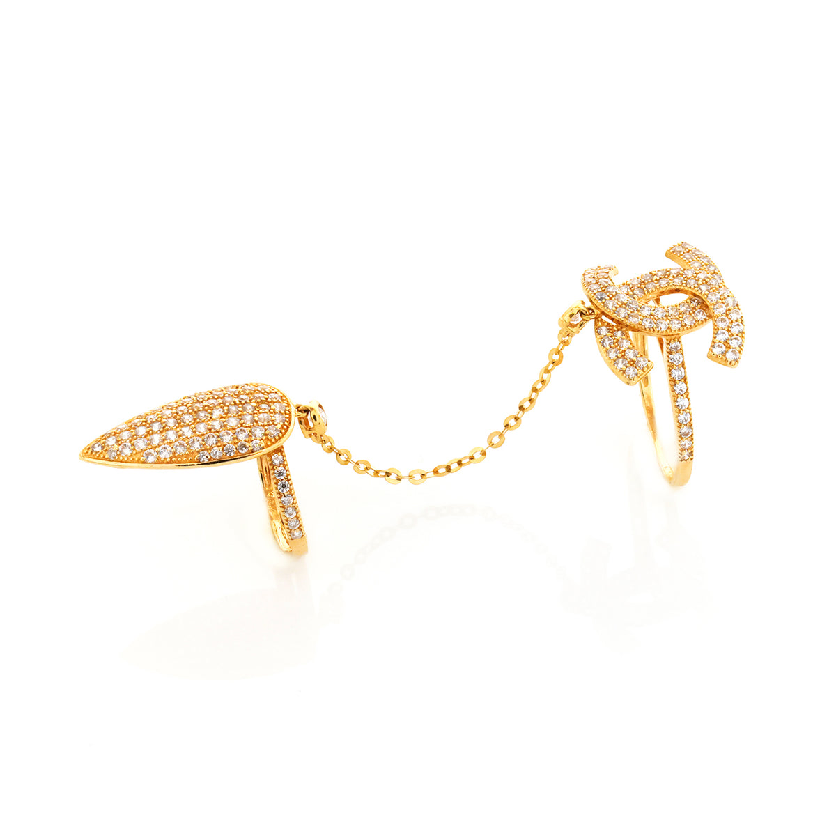 Gold earring with chain and leaf-like design on a white background