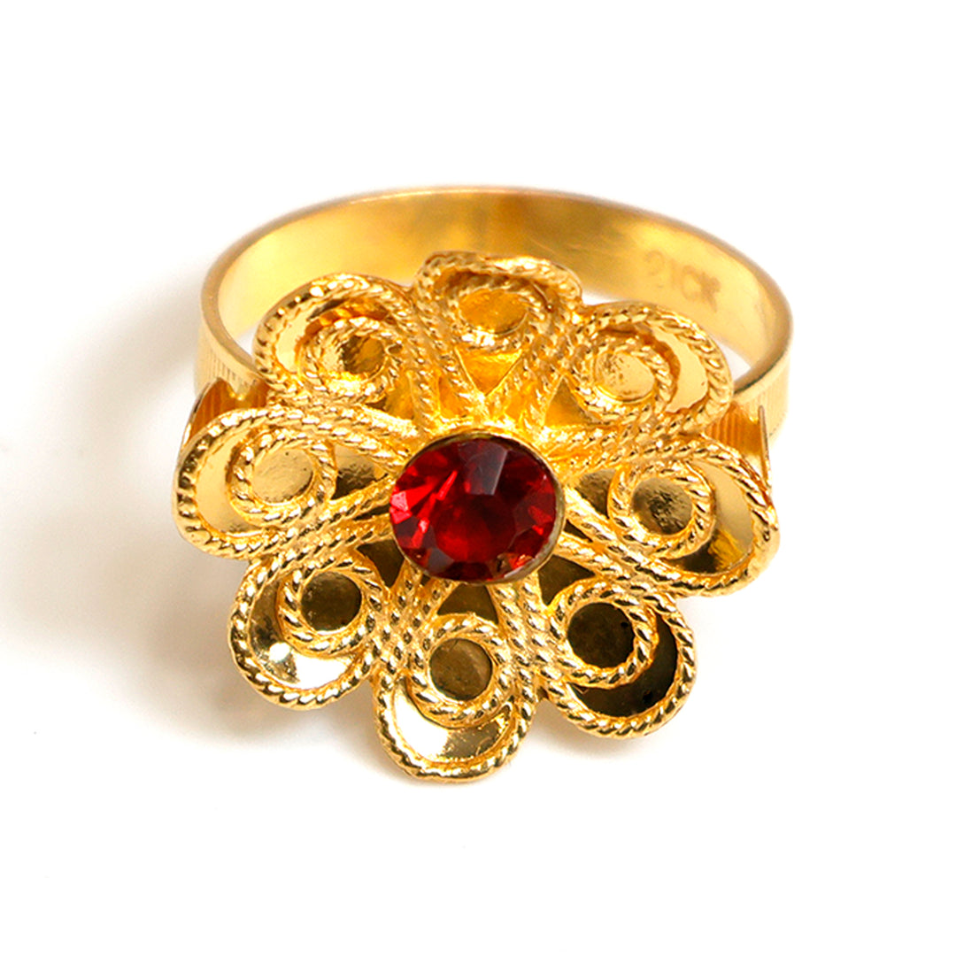 Gold ring with a red gemstone on a white background