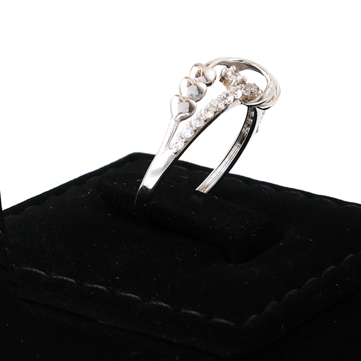 Silver ring with gemstones on a black cushion