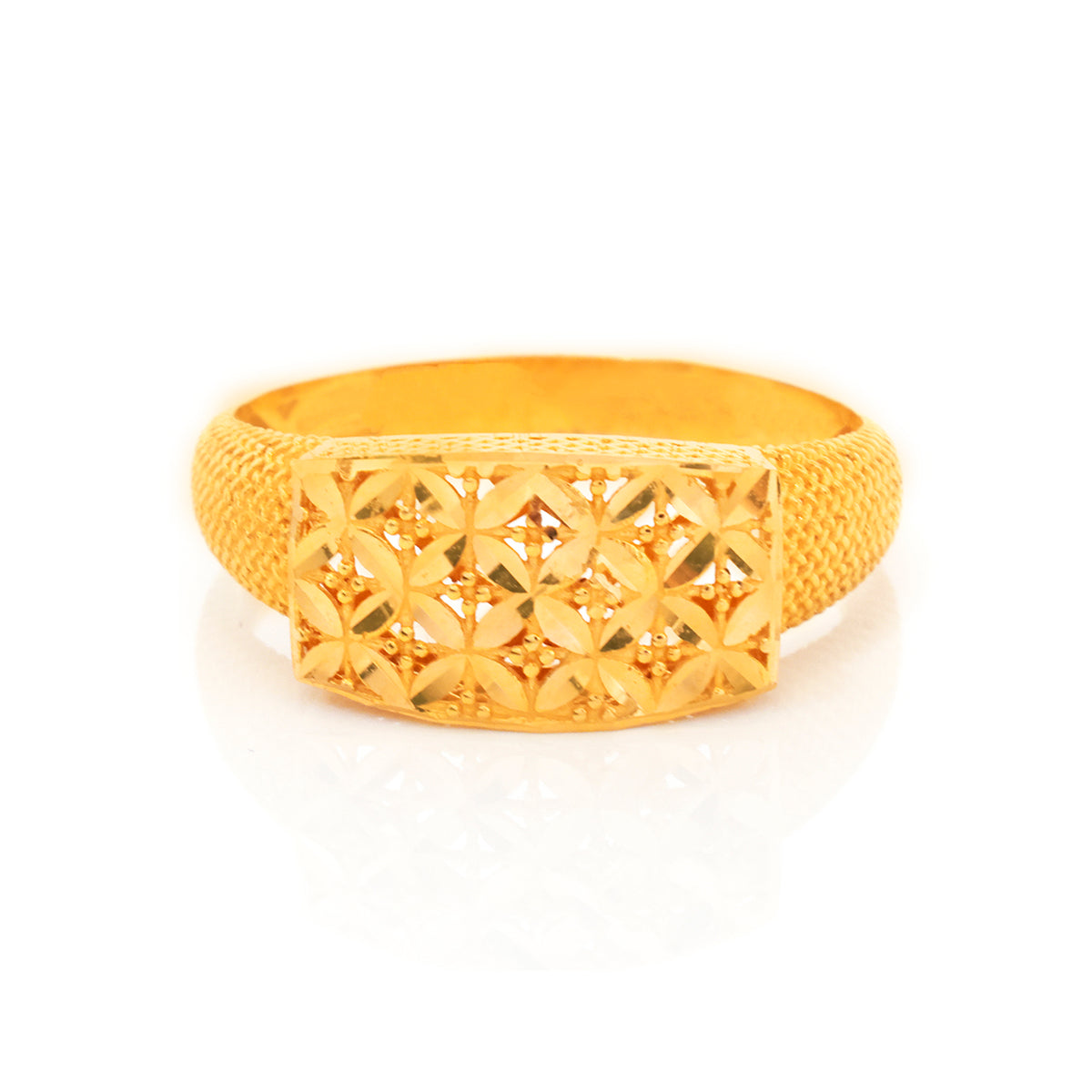 Gold ring with intricate design on a white background