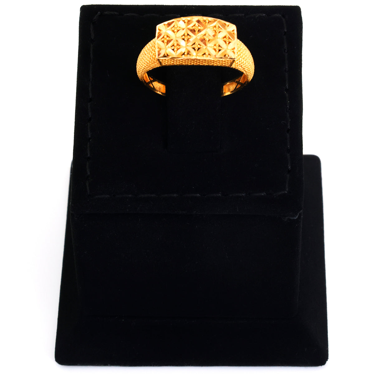 Gold ring on a black velvet stand with a white background