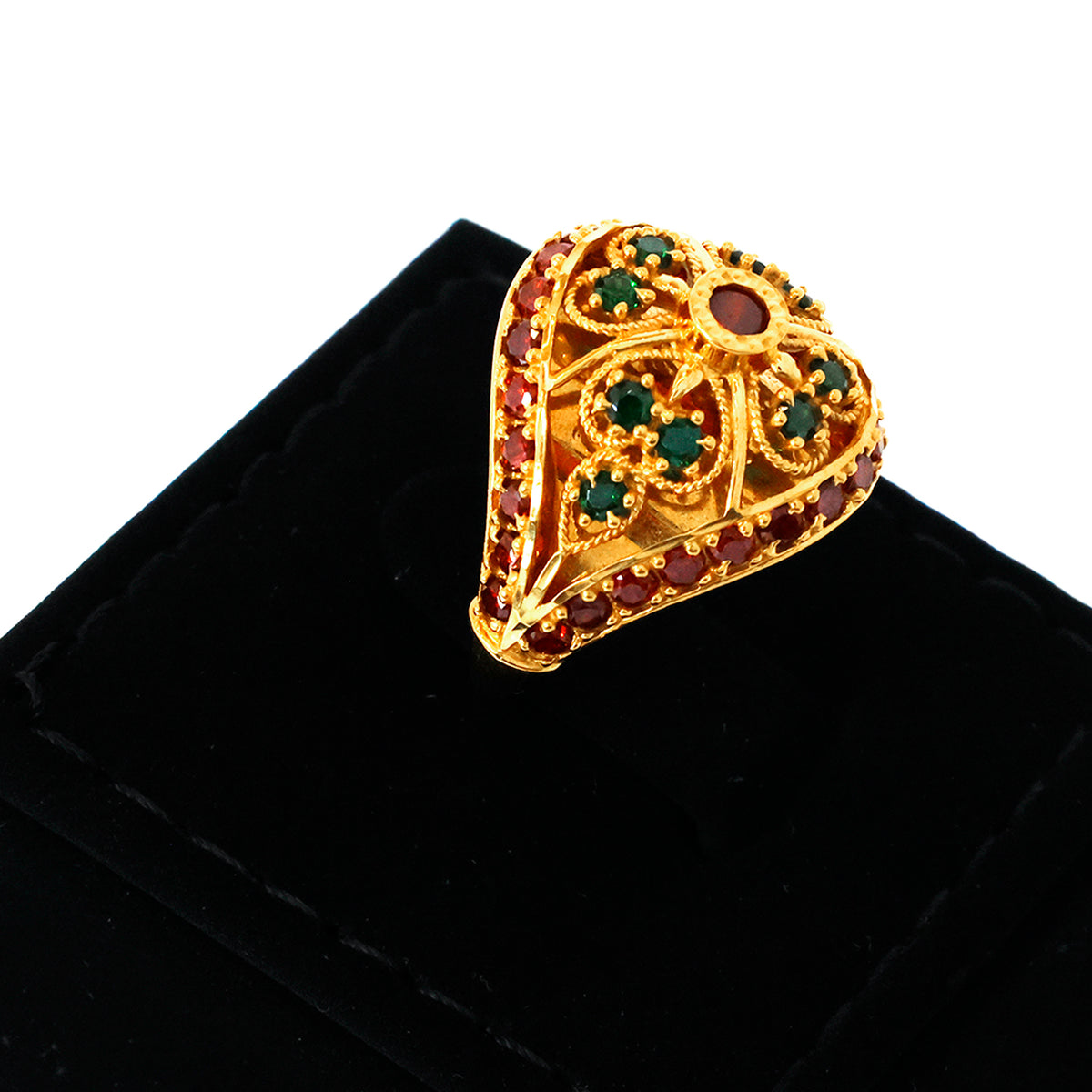 Gold ring with gemstones on a black velvet stand