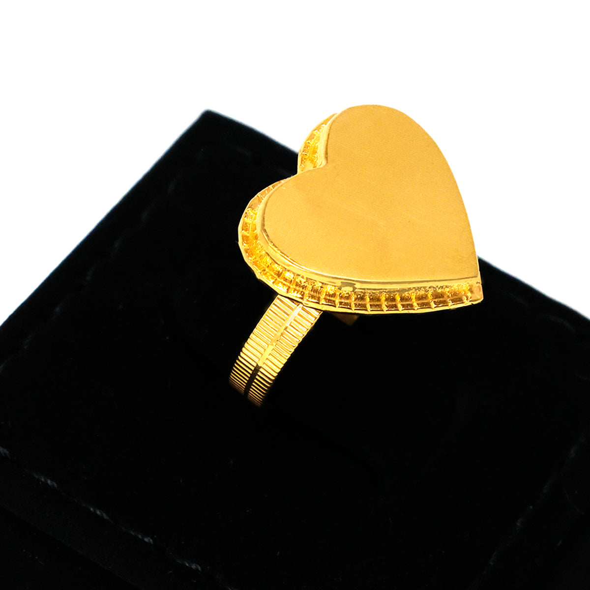 Gold heart-shaped ring on a black cushion