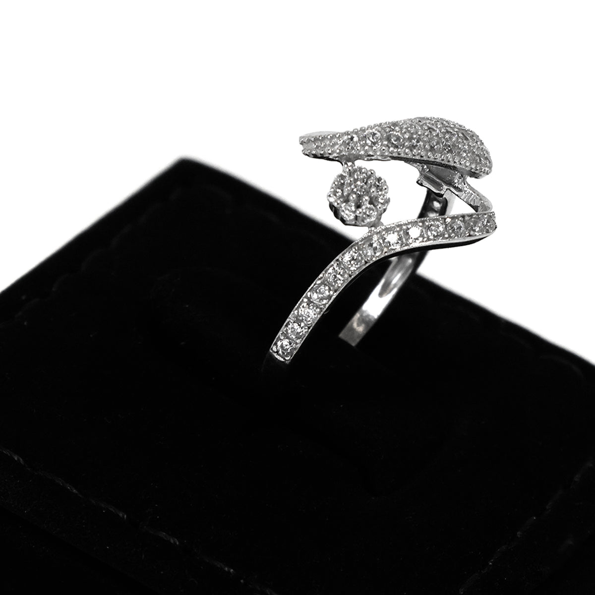 Silver ring with gemstones on a black cushion