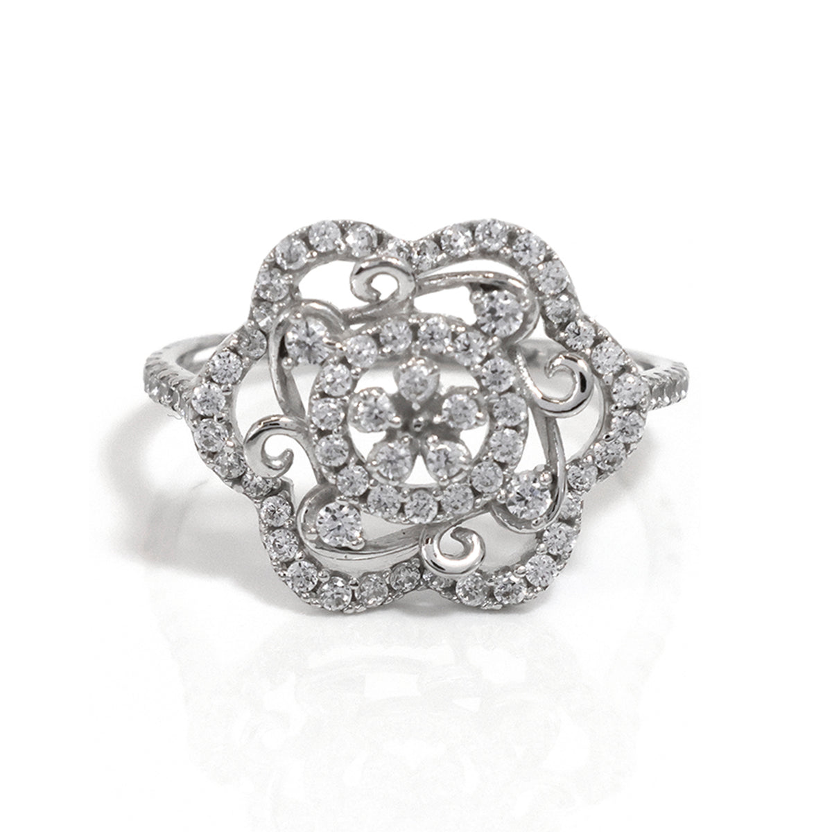 Silver ring with intricate design and sparkling stones on a white background