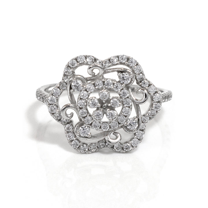 Silver ring with intricate design and sparkling stones on a white background