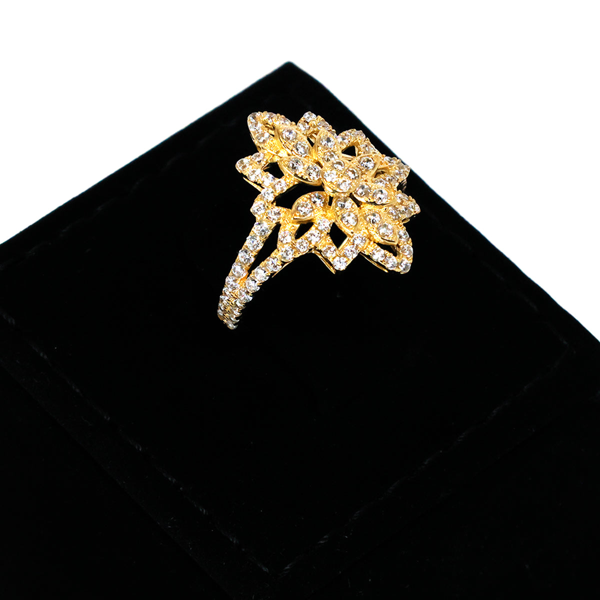 Gold brooch with crystal details on a black background