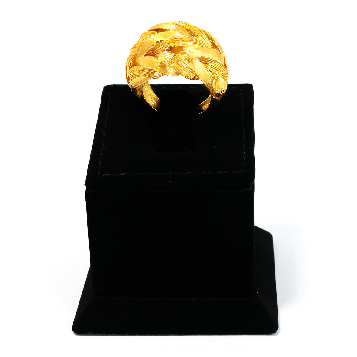 Gold ring on a black velvet stand against a white background