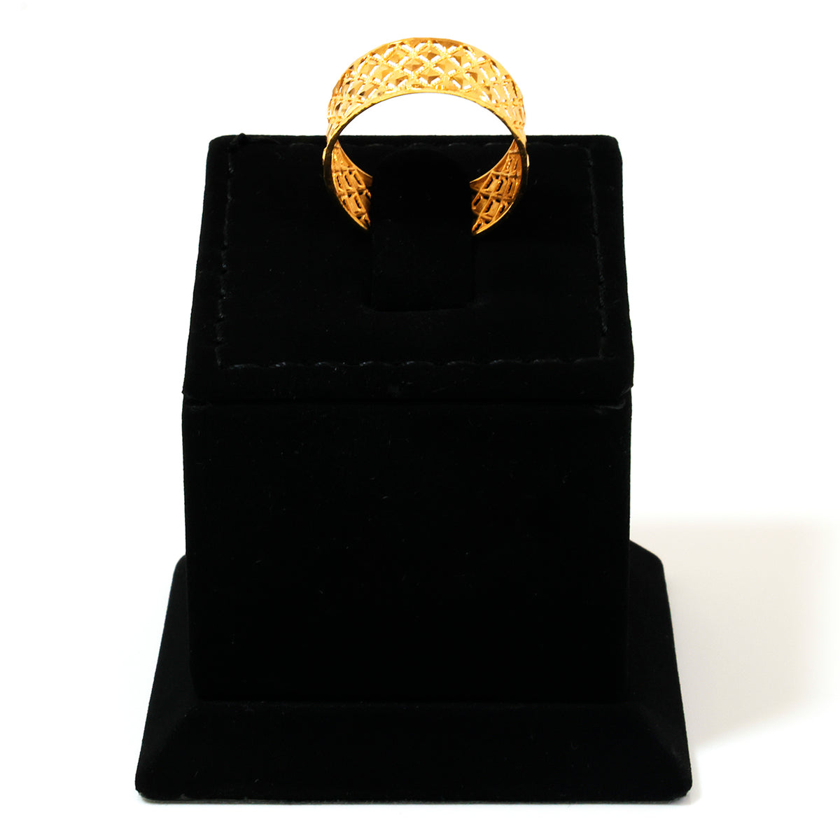 Gold ring on a black velvet stand against a white background