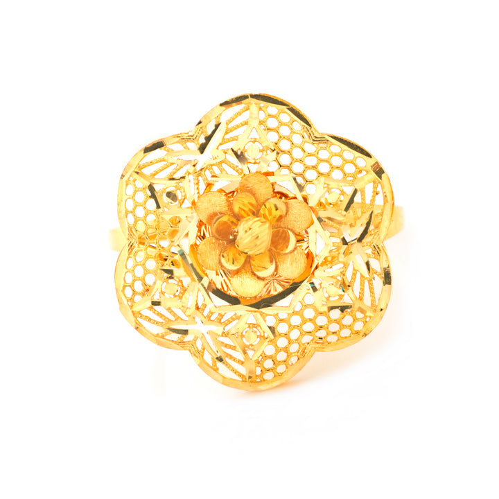 A gold filigree ring featuring a central floral motif with textured gold beads, set against a plain white background.