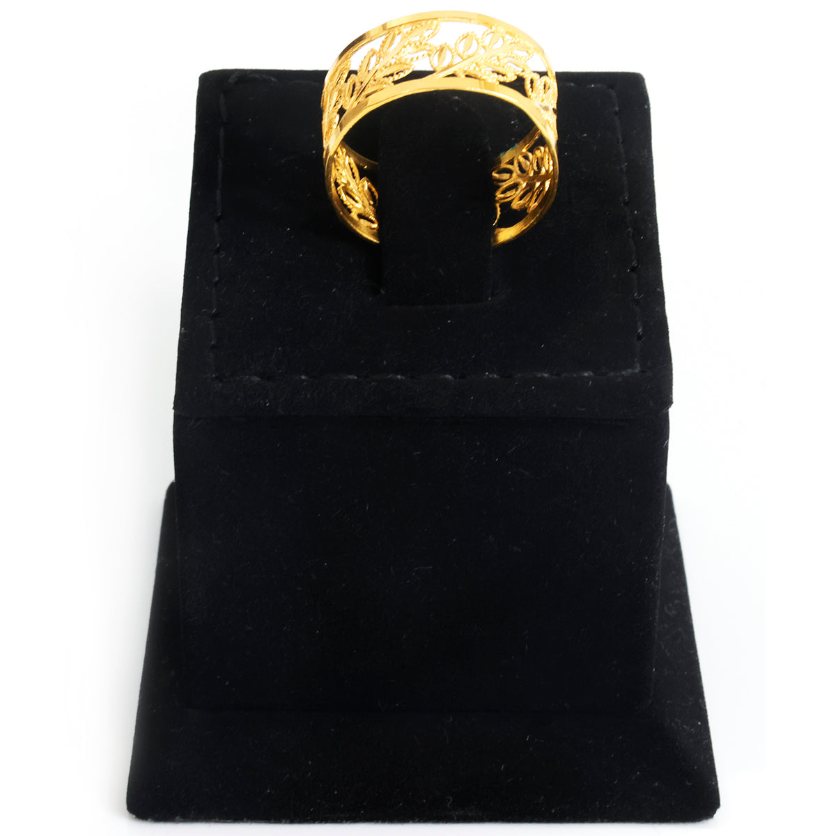 A gold ring with an intricate filigree pattern, displayed on a black velvet jewelry stand against a white background.