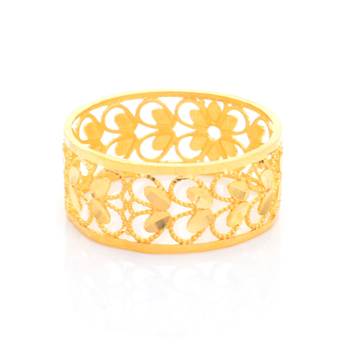 A gold filigree bangle bracelet with an openwork floral pattern, displayed on a clean white background with a soft reflection.