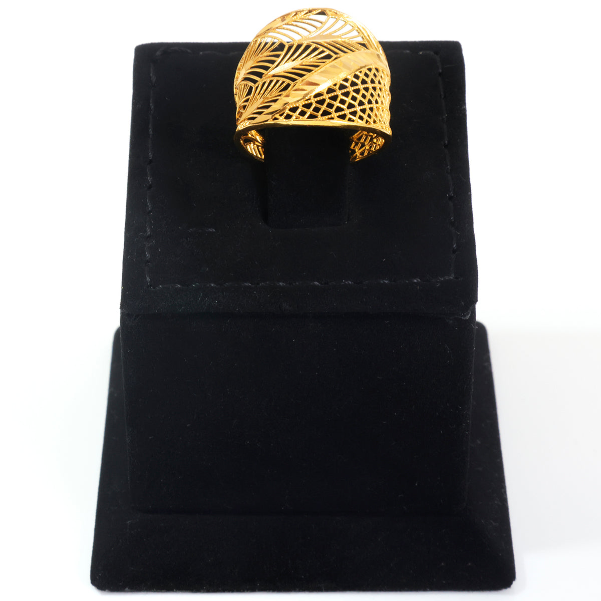 A gold-colored leaf-patterned ring displayed on a black velvet jewelry stand against a white background.