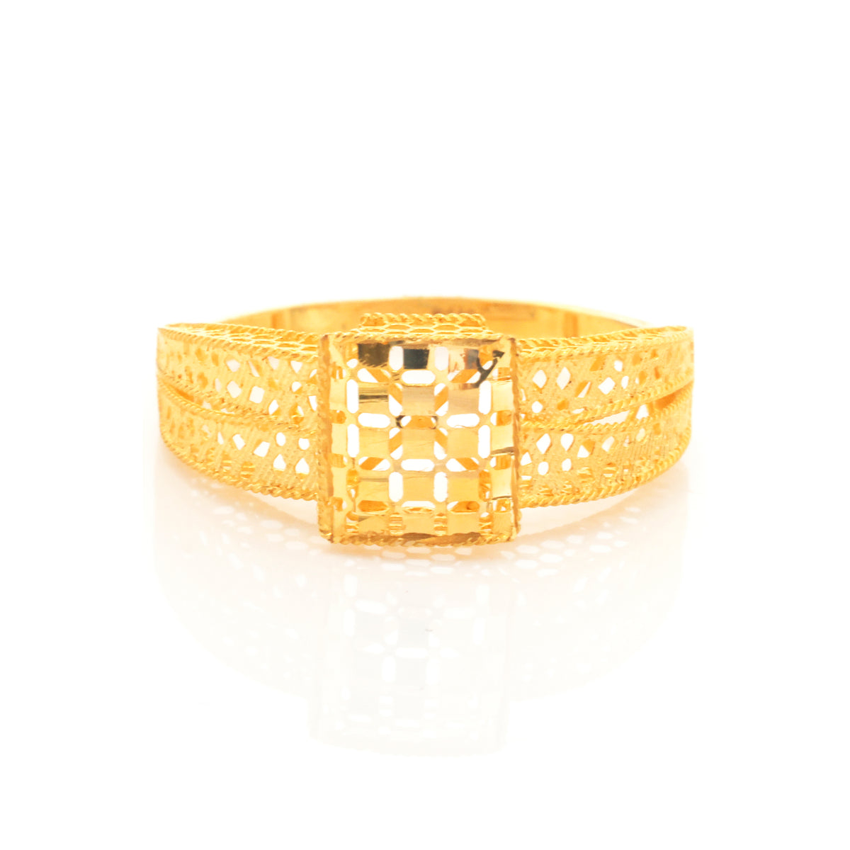 A gold filigree ring with a square-cut central stone, displayed on a clean white background with a soft reflection.