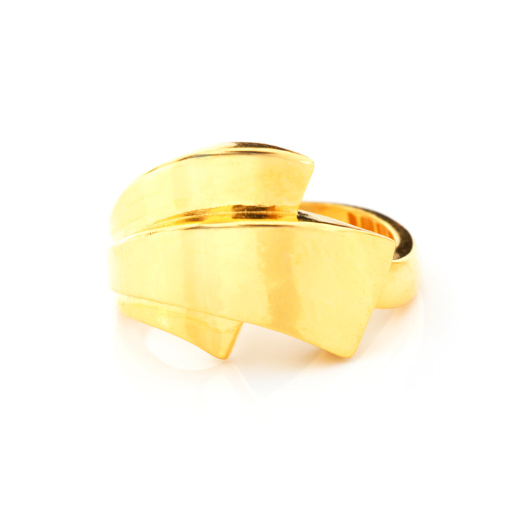 A gold wrap-style ring with a polished, layered ribbon-like design, photographed on a clean white background.
