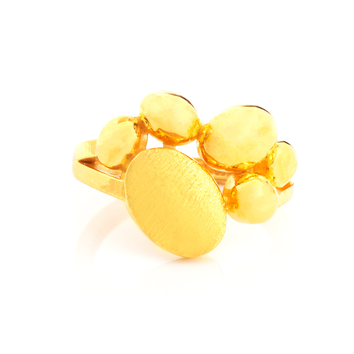 A gold ring featuring a large oval textured face surrounded by smaller rounded oval elements, photographed on a clean white background.