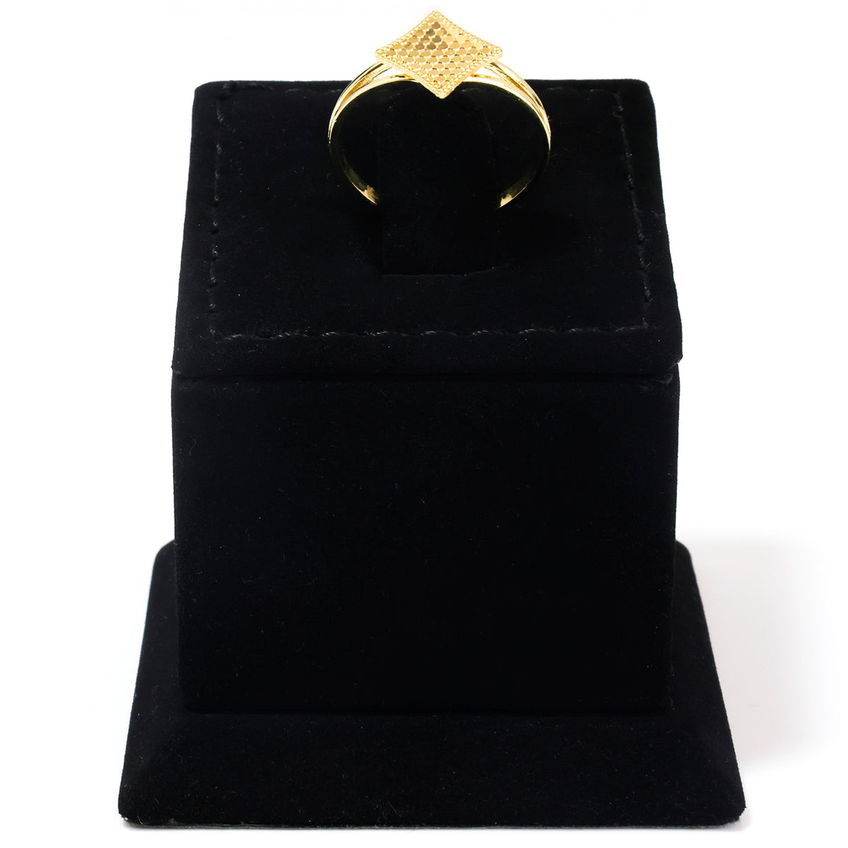 A gold ring with a textured, geometric star-like top is displayed on a black velvet ring box against a white background.