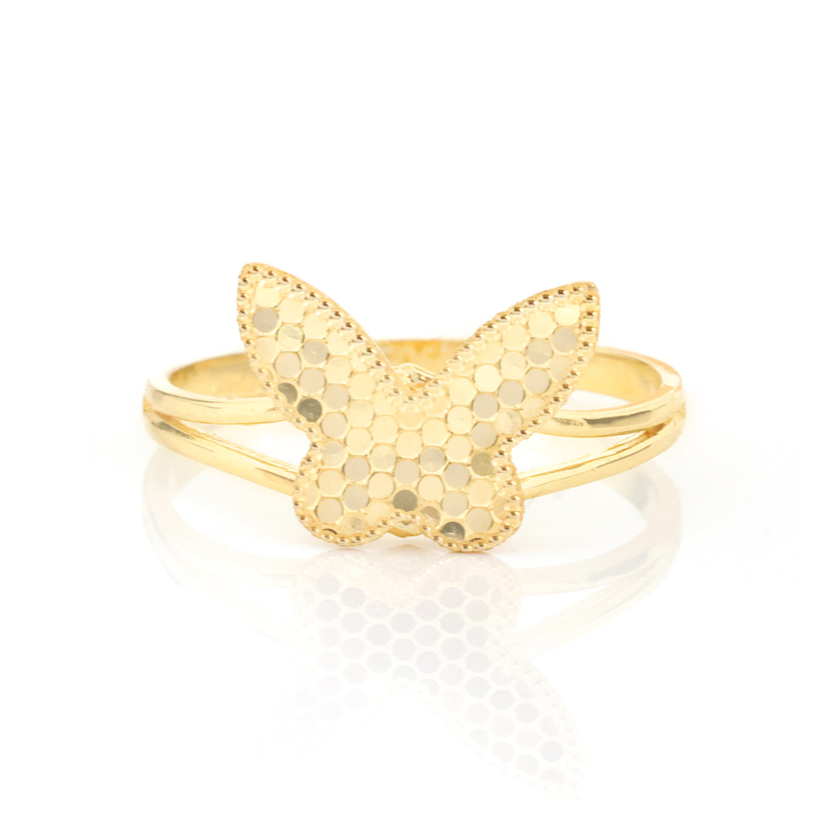 A gold butterfly ring with a textured honeycomb pattern on the wings and a smooth polished band, displayed on a clean white reflective surface.