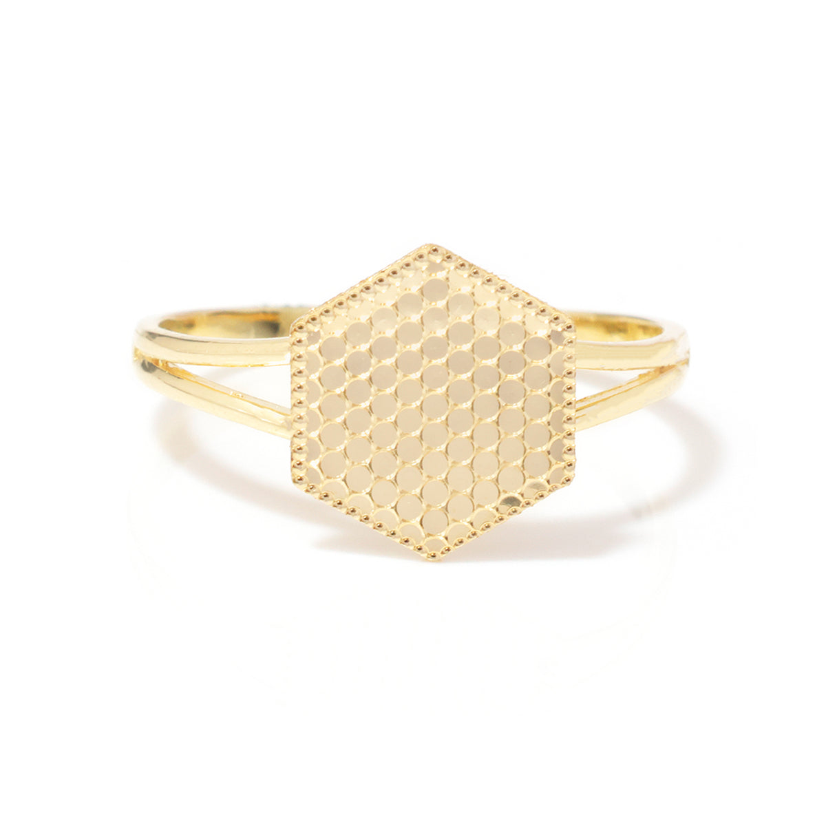 A gold hexagonal ring with a textured honeycomb pattern on the top and a slim band, shown on a clean white background.