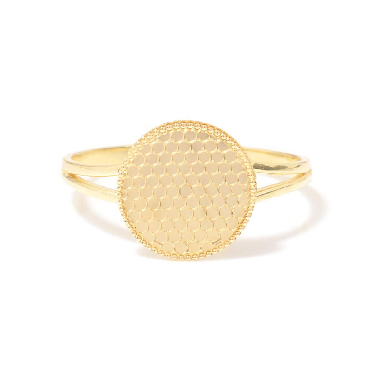 A gold ring with a textured, honeycomb-patterned oval face and a smooth, polished band, shown on a clean white background.