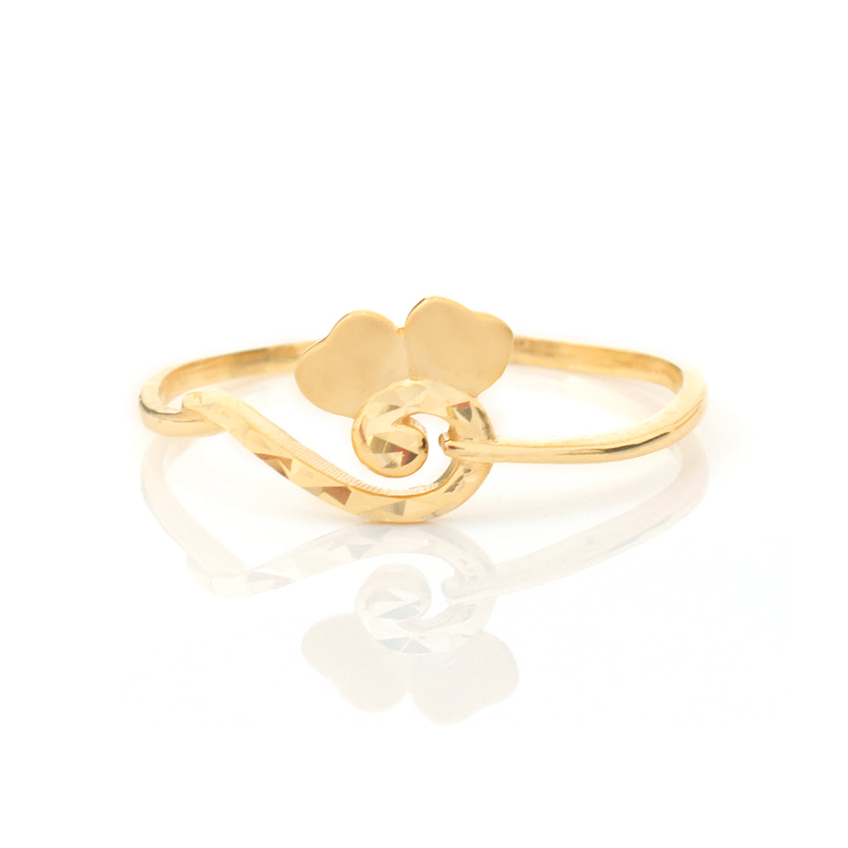 A gold-plated open band ring featuring a stylized four-leaf clover and swirl design, displayed on a clean white reflective surface.