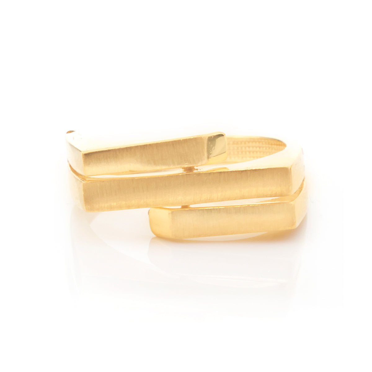 A gold-plated wrap ring with a brushed texture, featuring three overlapping horizontal bands, shown on a clean white background with a soft reflection.