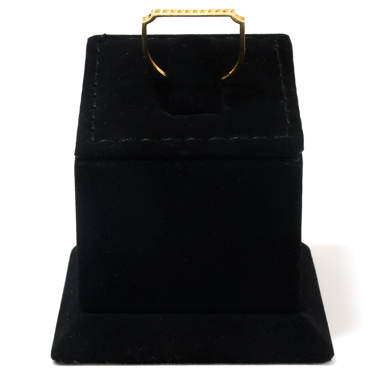 A gold ring displayed on a black velvet jewelry box stand against a white background.