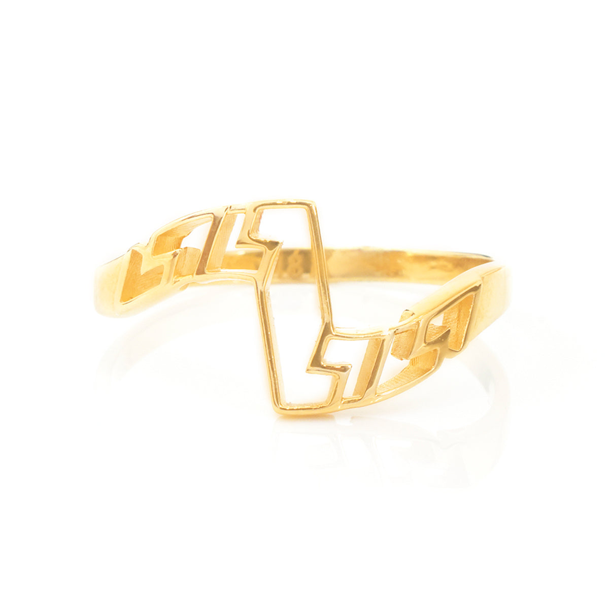 A gold geometric openwork ring with a zigzag design, photographed on a clean white background with a soft reflection.
