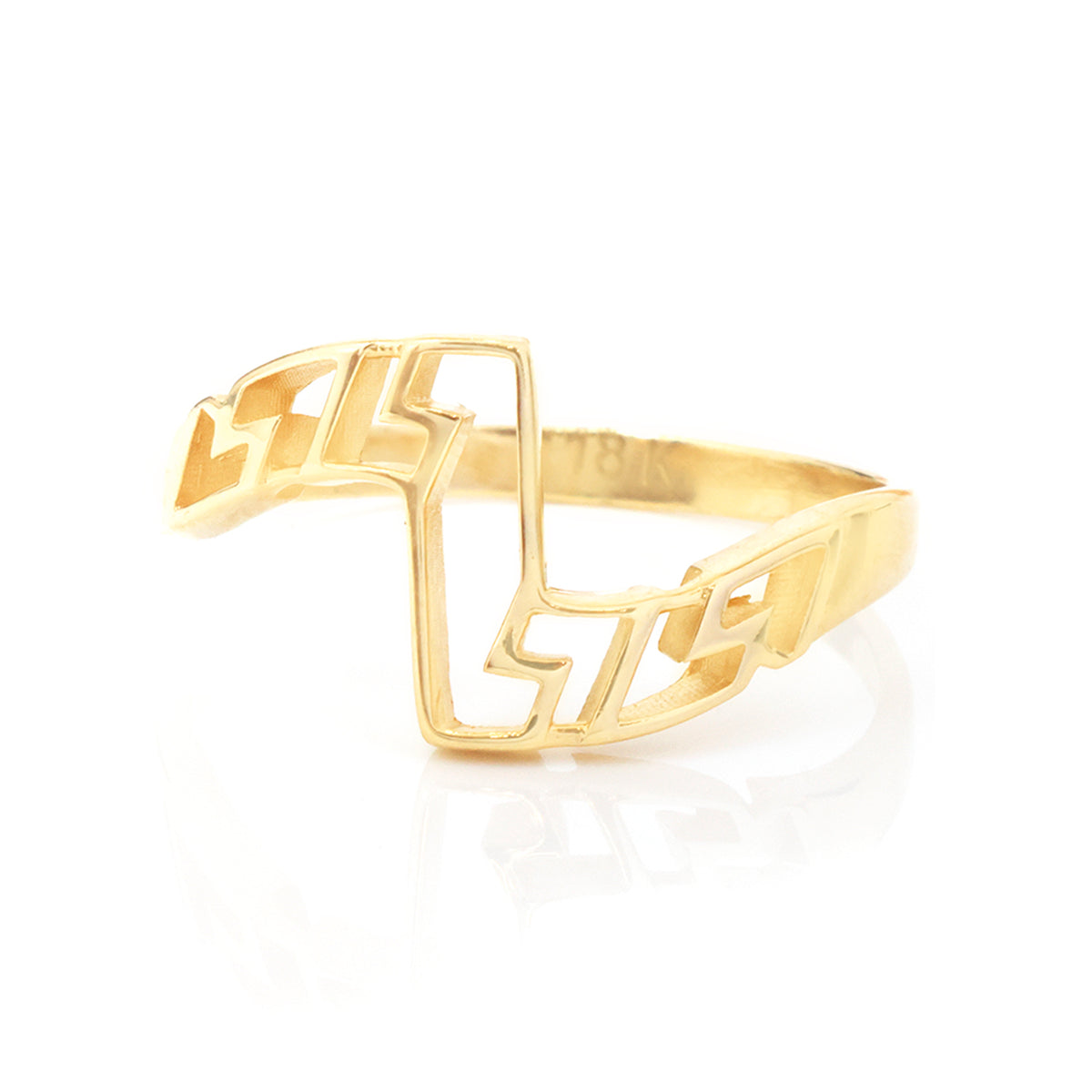 A gold openwork geometric ring with a modern, abstract design, displayed on a clean white background with a soft reflection.