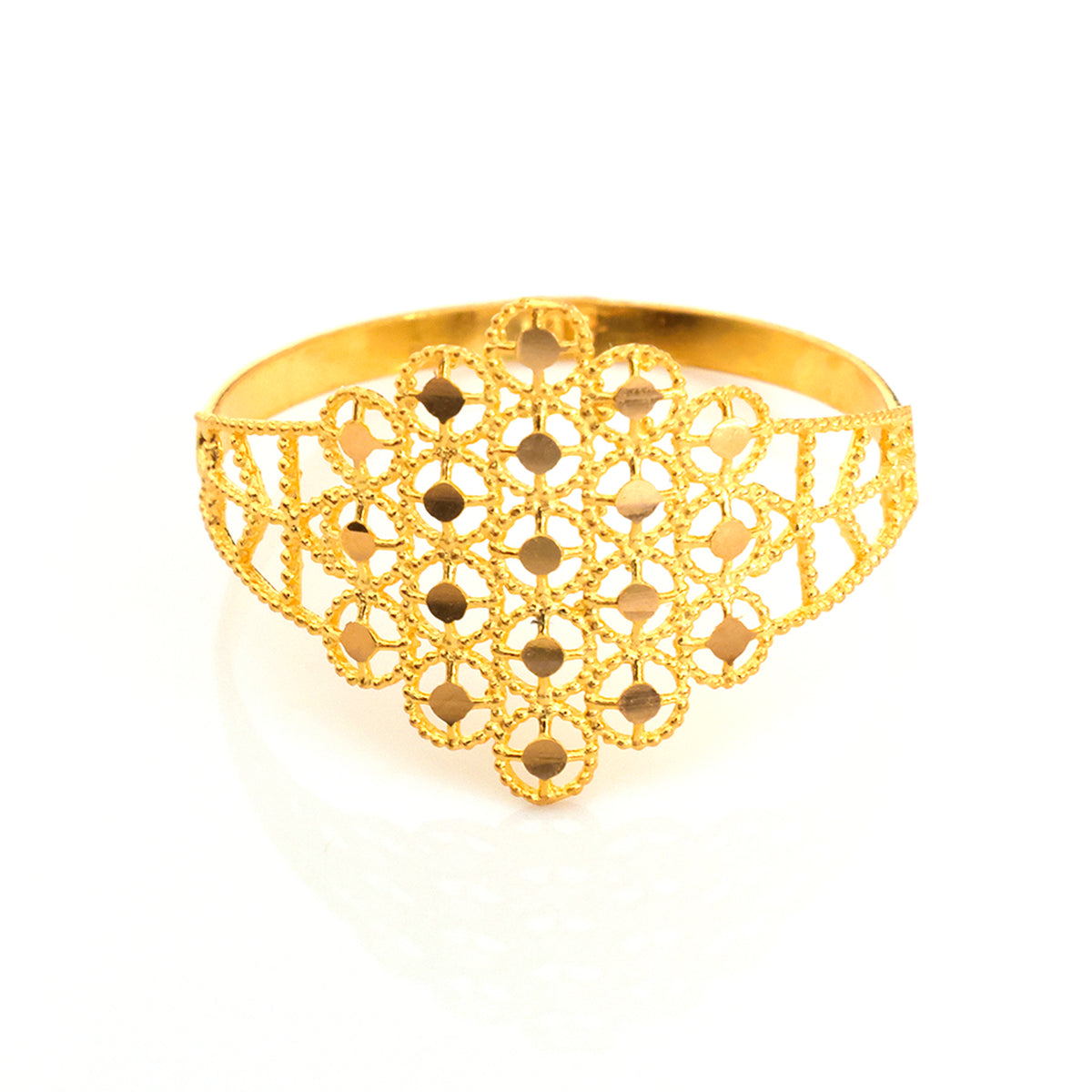 A gold filigree cuff bracelet with an intricate openwork pattern, photographed on a clean white background.