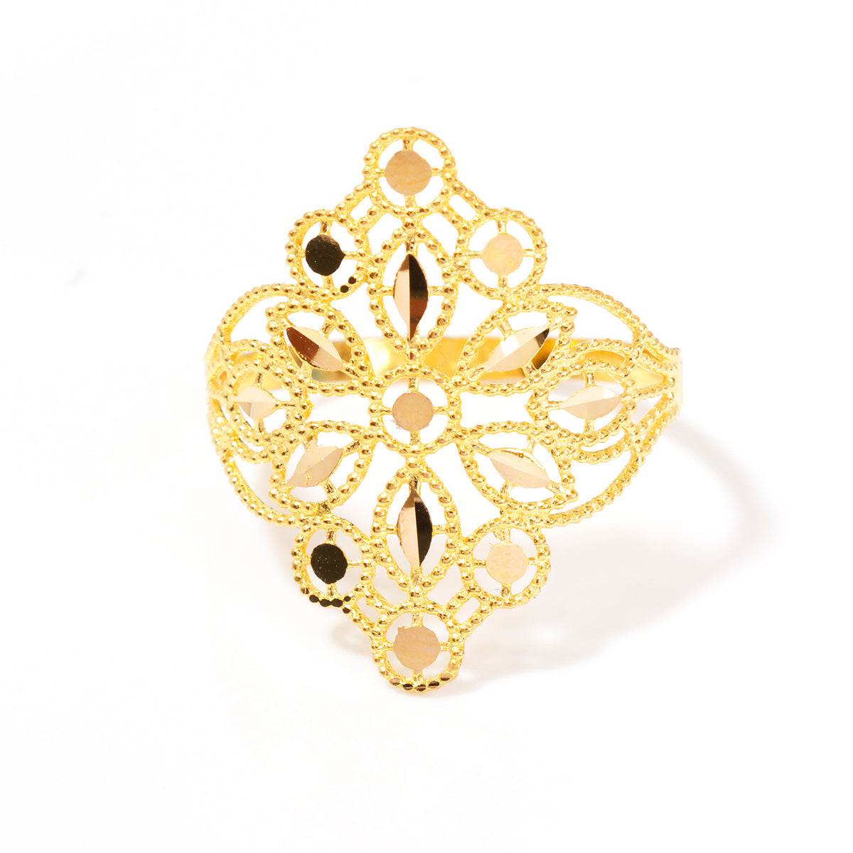A gold filigree ring with openwork geometric patterns and faceted clear stones, photographed on a clean white background.