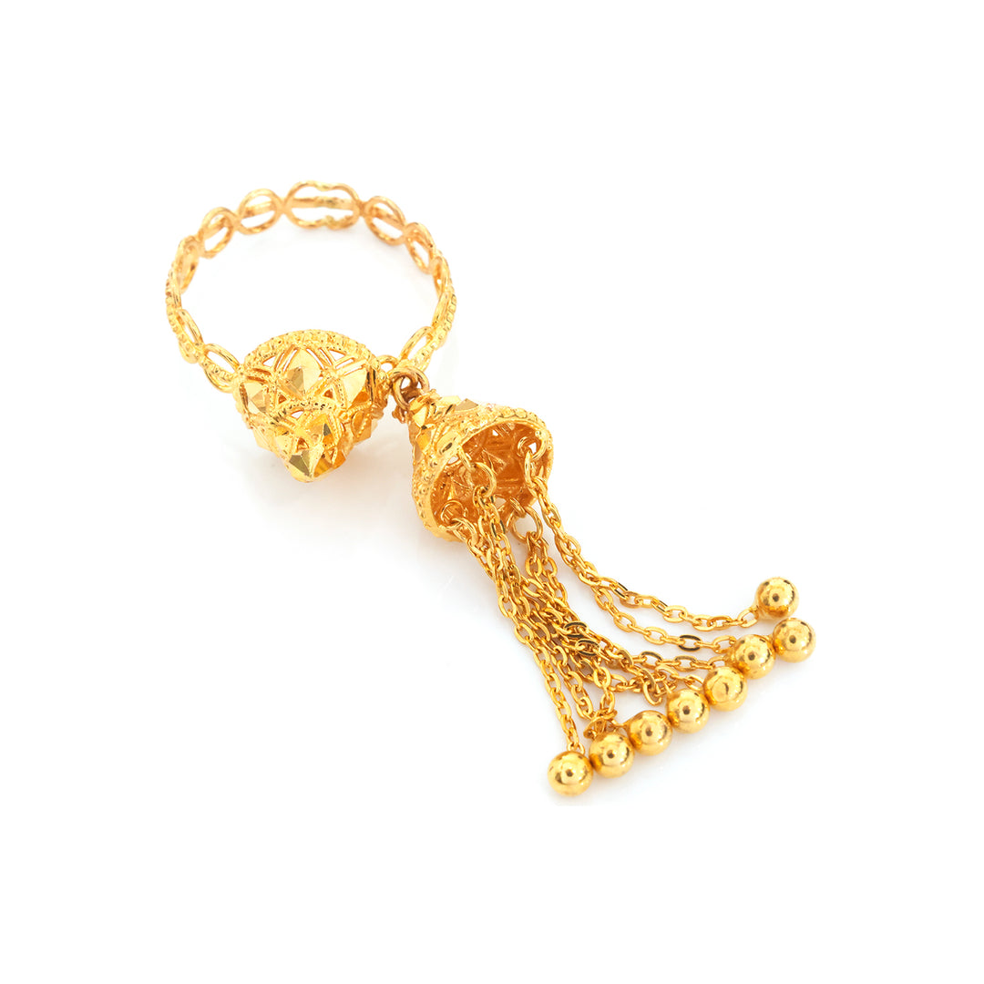 A gold-toned traditional Indian tassel necklace (Kara) featuring a detailed filigree ball, a decorative bell-shaped pendant, and multiple dangling chains ending in small gold beads, set against a plain white background.