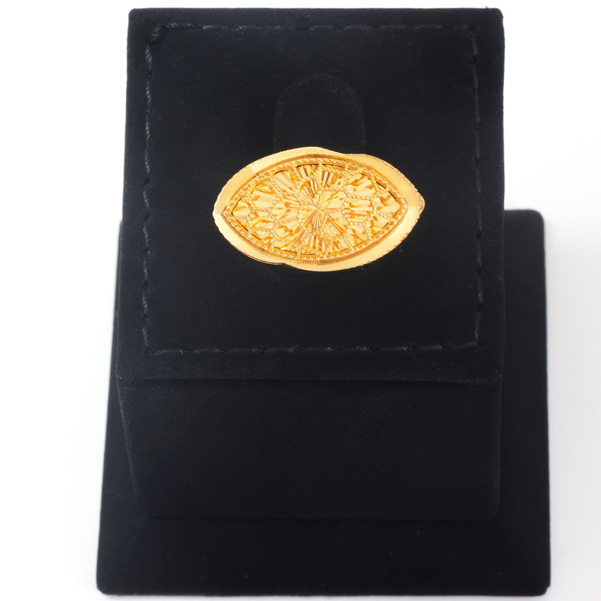 A gold-toned oval pendant with an intricate floral or sunburst pattern, displayed on a black velvet jewelry stand against a white background.