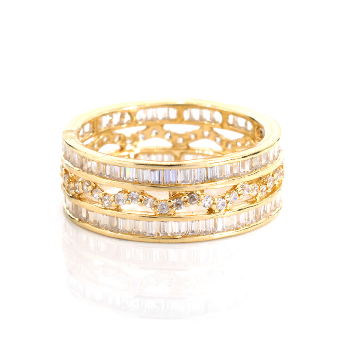 A gold ring with multiple rows of clear baguette and round-cut stones, displayed on a clean white background with a soft reflection below.