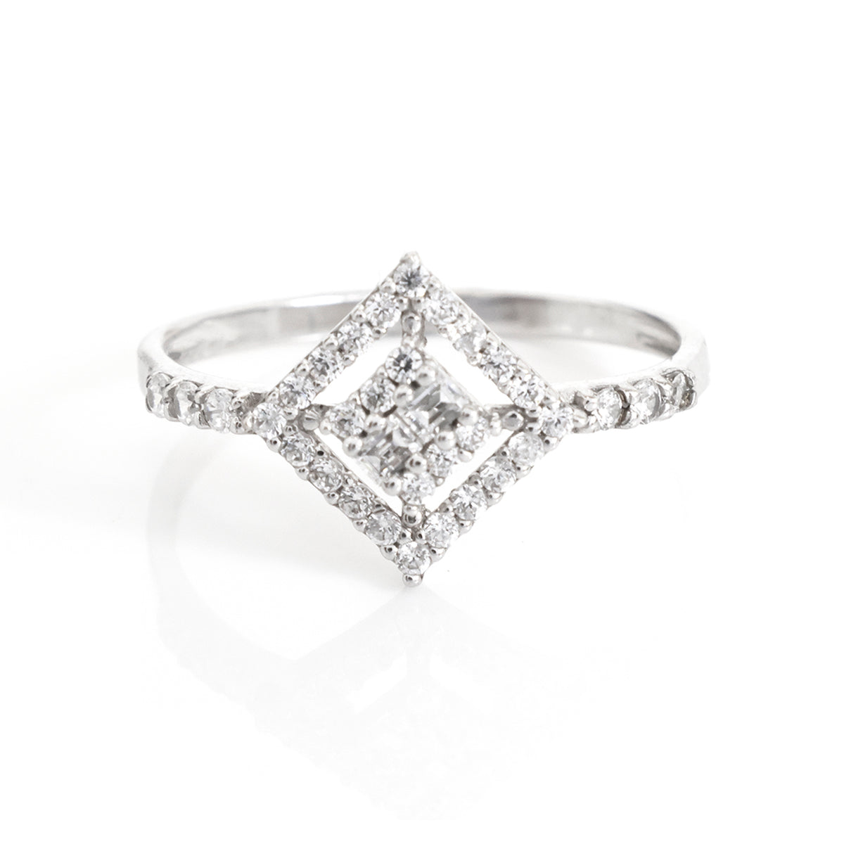 A silver diamond ring featuring a double halo design with a central princess-cut diamond and smaller diamonds along the band, set against a clean white background.