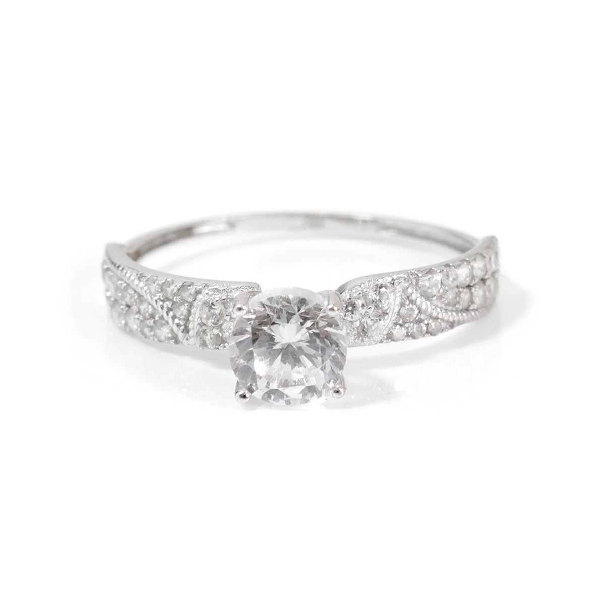 A silver-toned diamond engagement ring with a round-cut center stone and a filigree band set with small diamonds, shown on a plain white background.