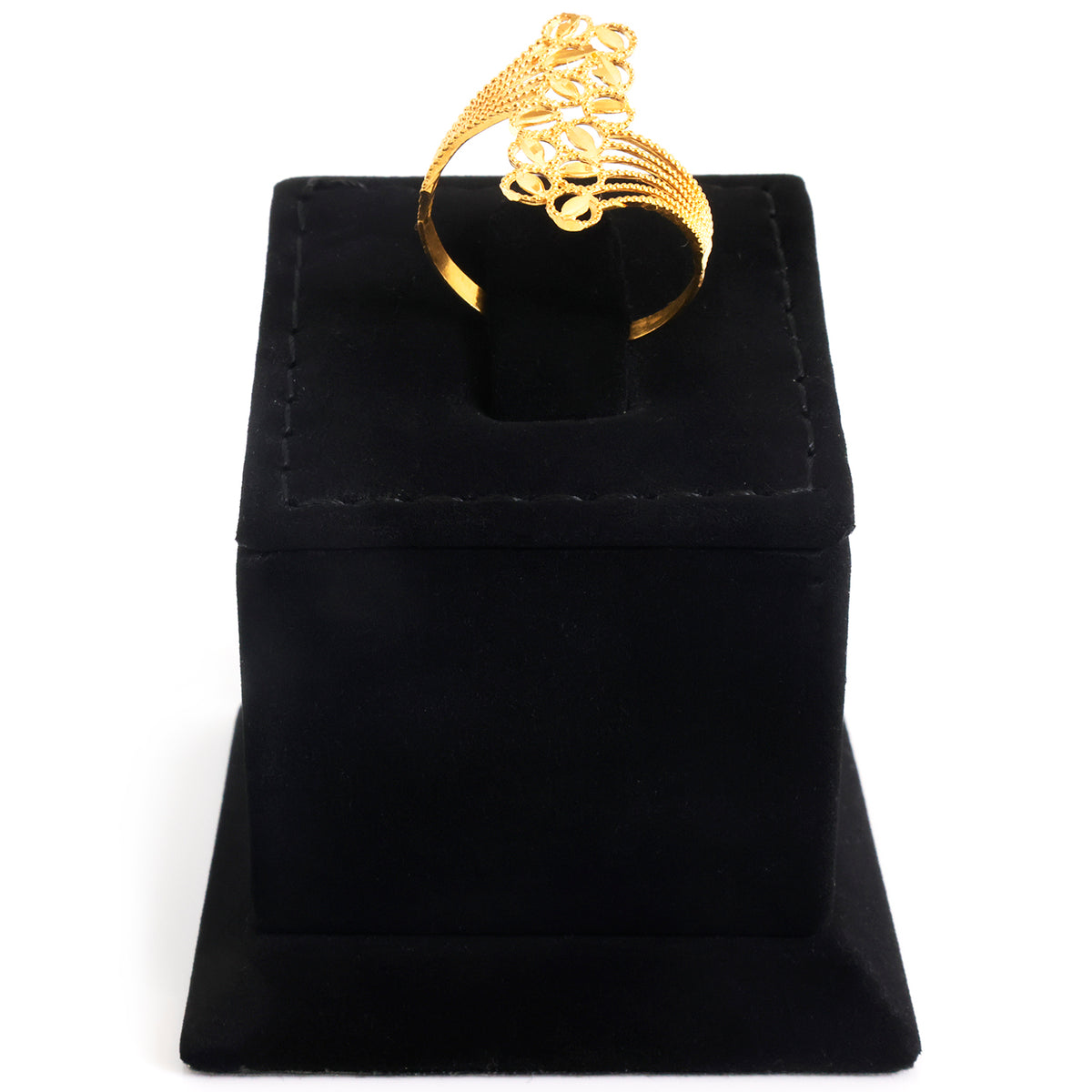 A gold ring with an intricate, textured openwork design displayed on a black velvet ring box against a white background.