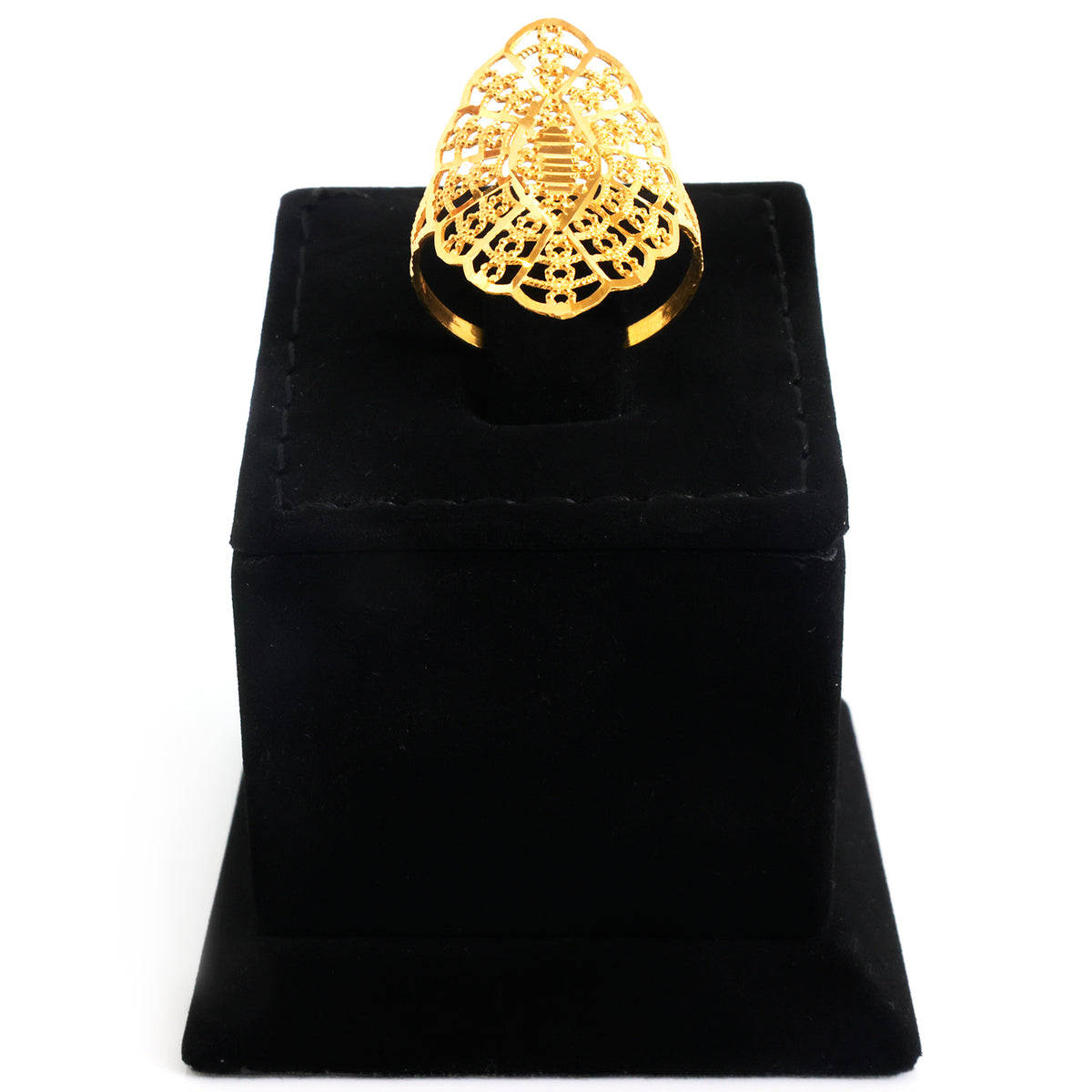 A gold ring with an intricate filigree teardrop-shaped top, displayed on a black velvet jewelry box against a white background.