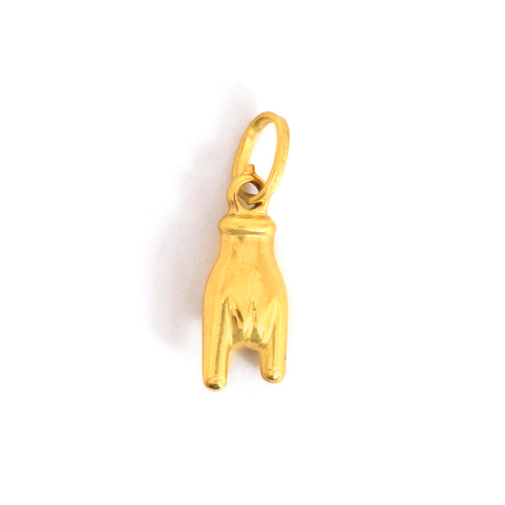 ذهب dog paw charm on white background