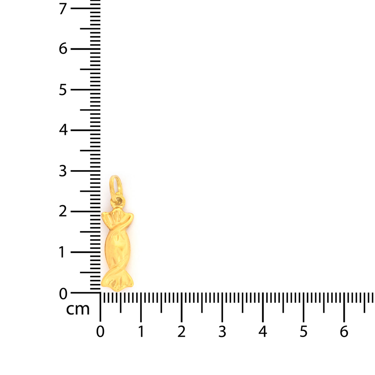 Gold pendant next to a ruler on a white background