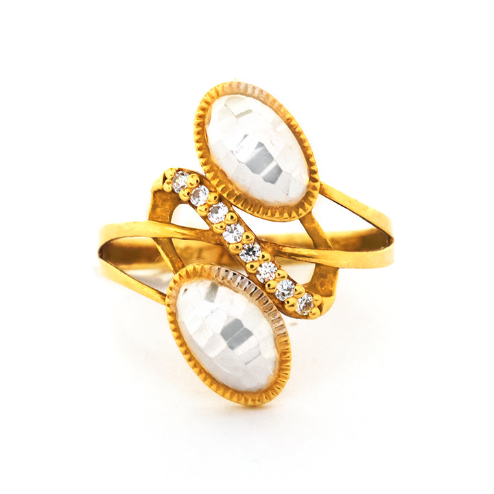 Gold ring with two large white stones and small diamonds on a white background
