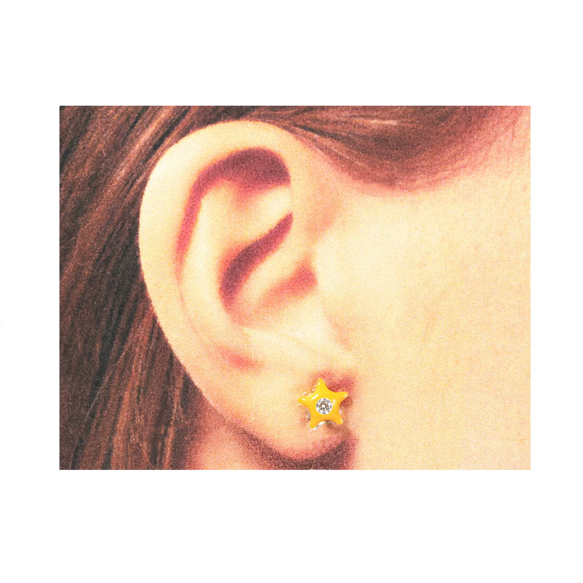 Close-up of an ear wearing a star-shaped earring with a yellow center.