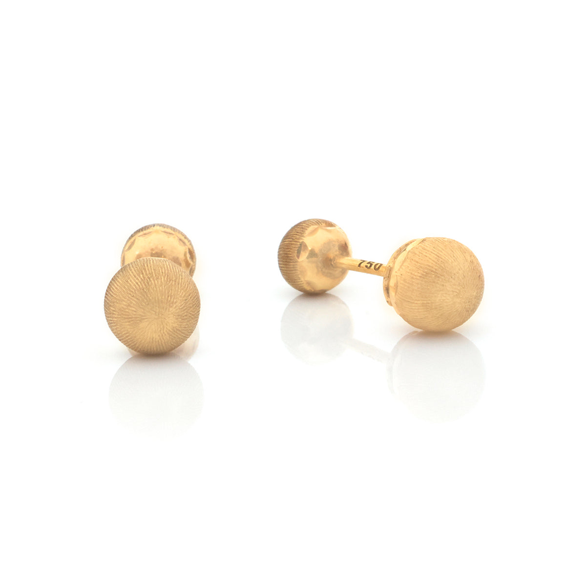 A pair of gold stud earrings with a textured, sunburst-like circular face, shown on a clean white background with soft reflections.