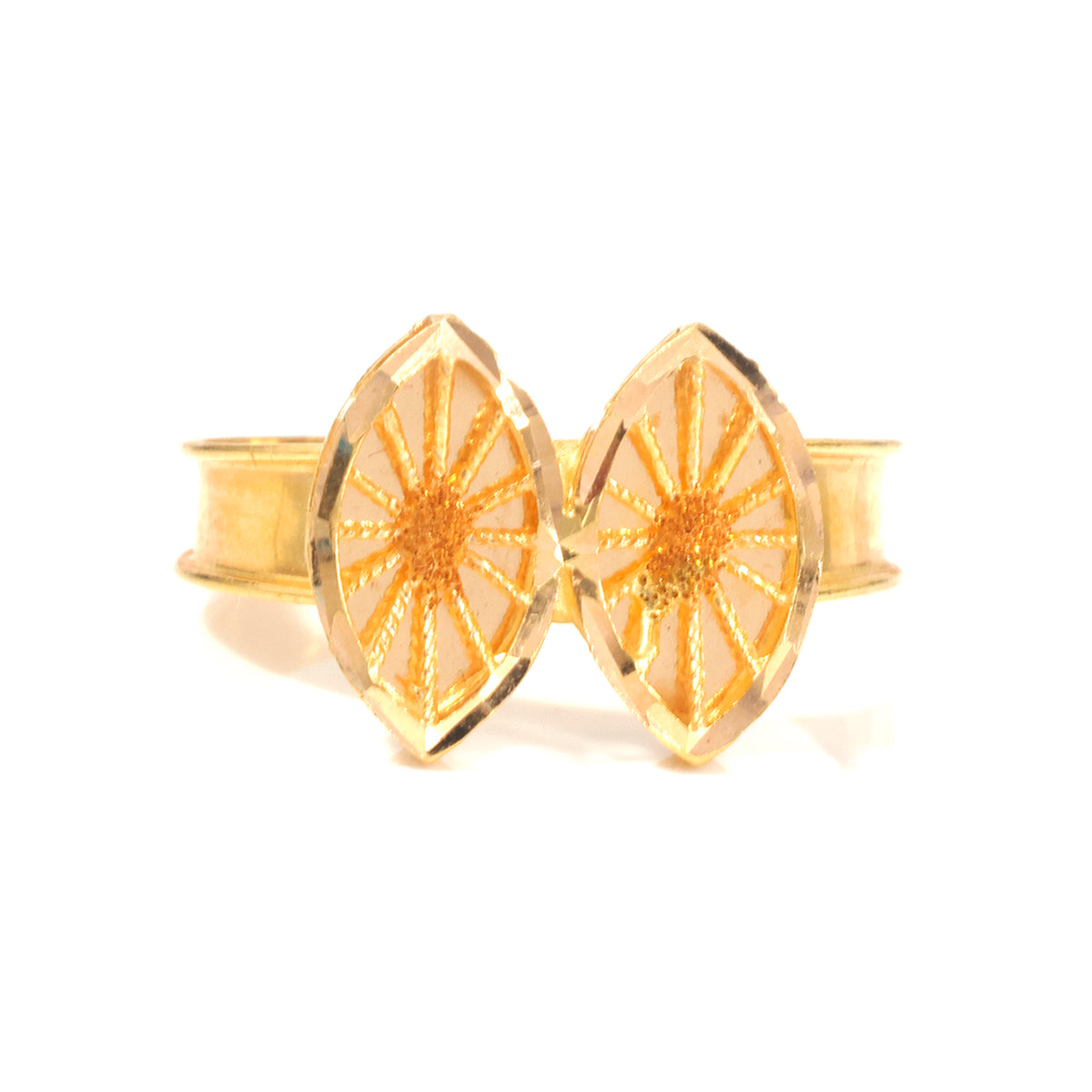 A gold-tone cuff bracelet with two large, overlapping marquise-shaped ends featuring a textured sunburst star pattern on a white background.