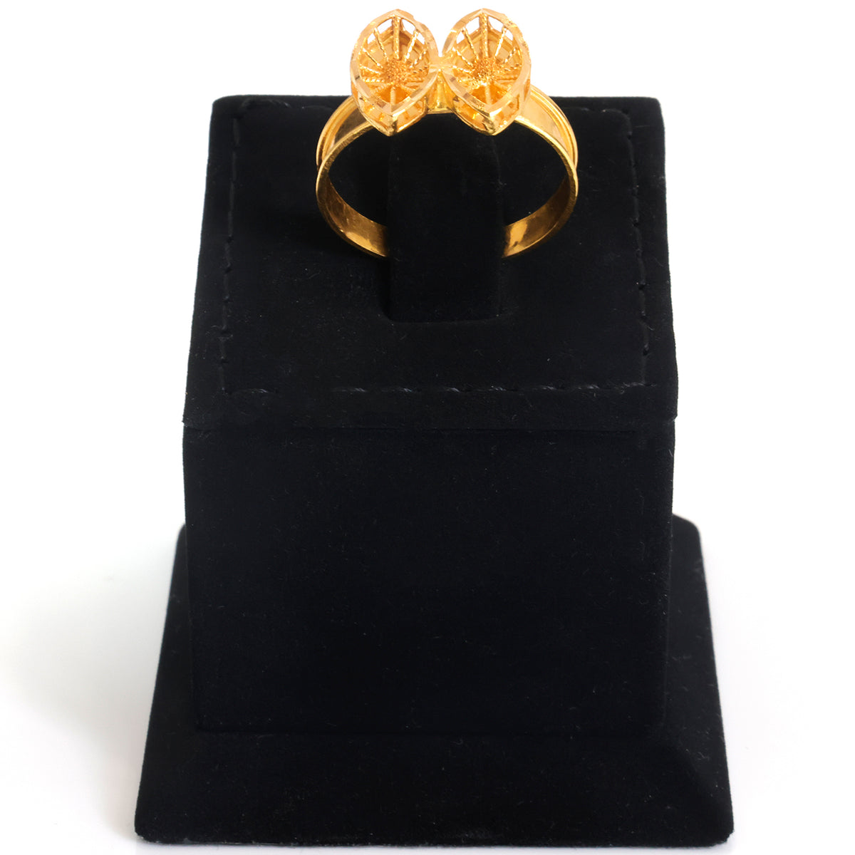 A gold ring with a double heart-shaped pavé setting, displayed on a black velvet ring box stand against a white background.