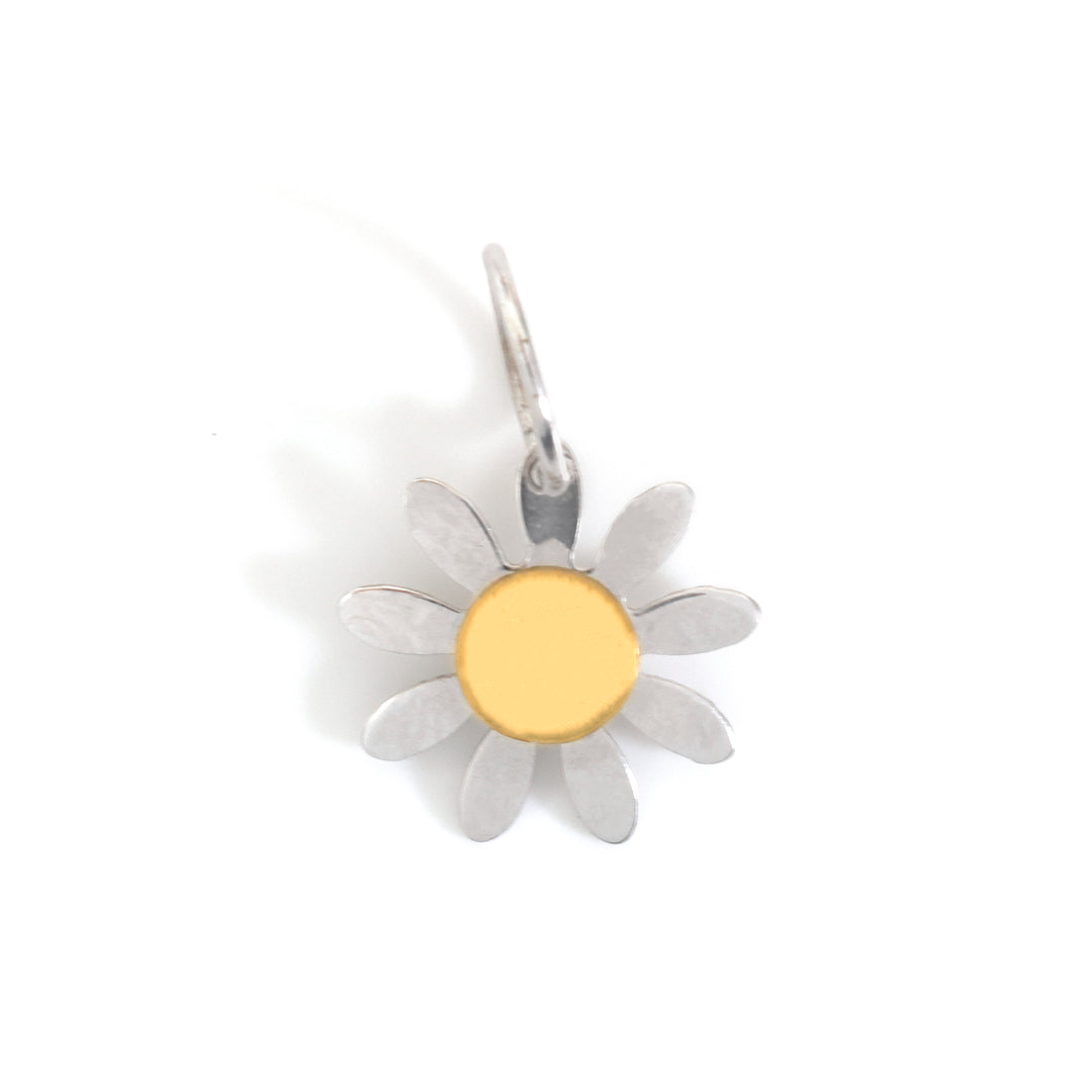 A silver daisy flower charm with a polished gold center, shown on a plain white background.