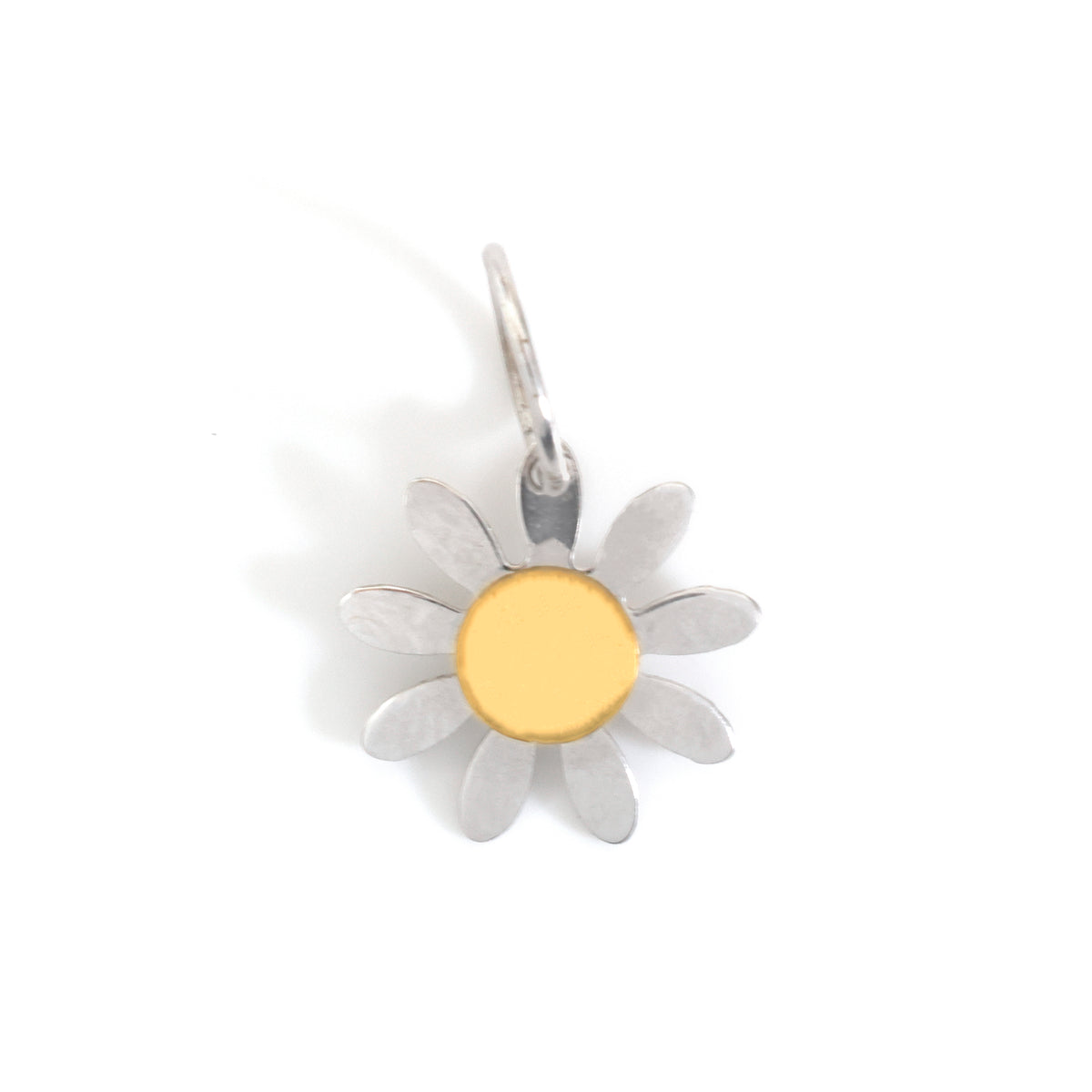 A silver daisy flower charm with a polished gold center, shown on a plain white background.